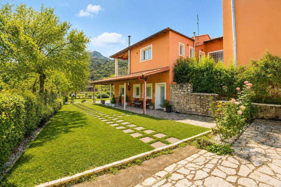 Accommodation's entrance with garden and outdoor seating area