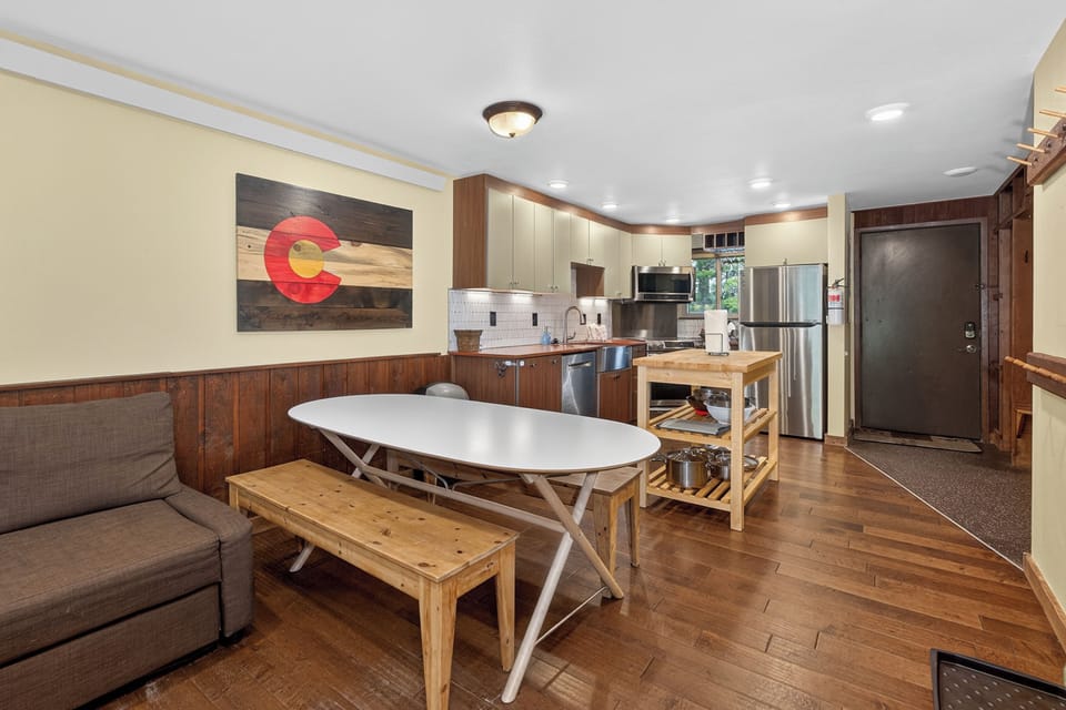 Step into your comfortable open-concept space where rustic charm meets modern convenience. Cook memorable meals in your fully equipped kitchen, gather around the dining table, and unwind on the cozy sofa after mountain adventures.