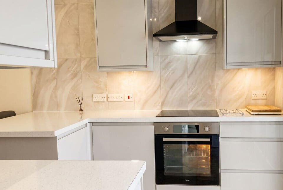 Modern oven and induction hob ready for home-cooked dinners.