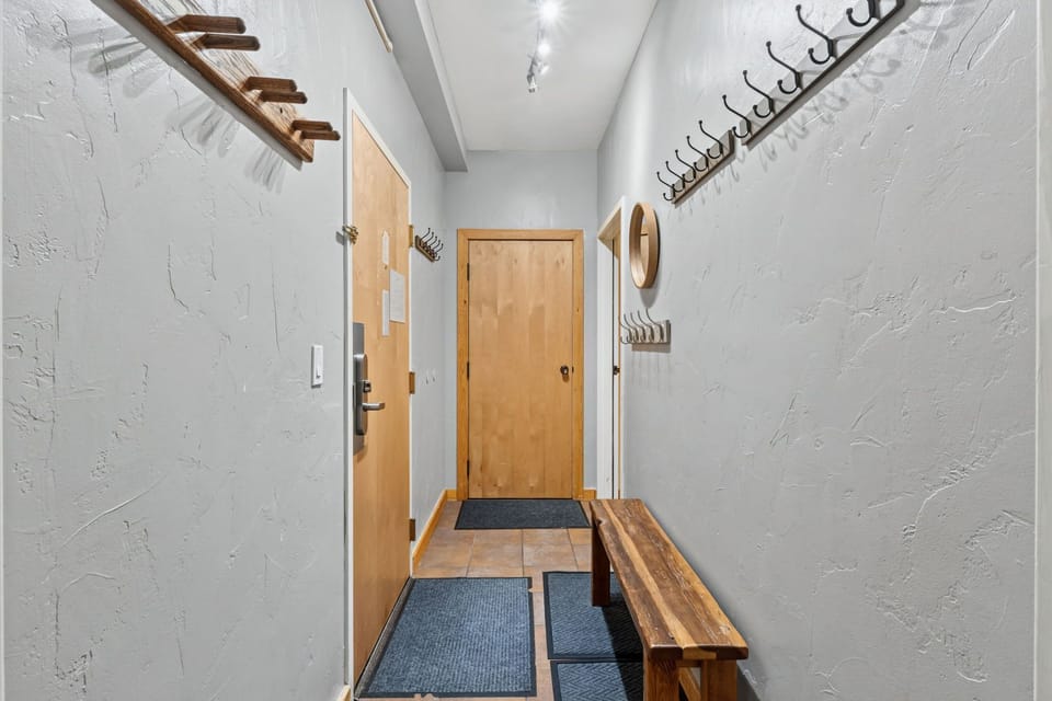Bright, welcoming entryway with rustic wood accents, ski storage, and plenty of hooks to keep your gear organized and ready for adventure.