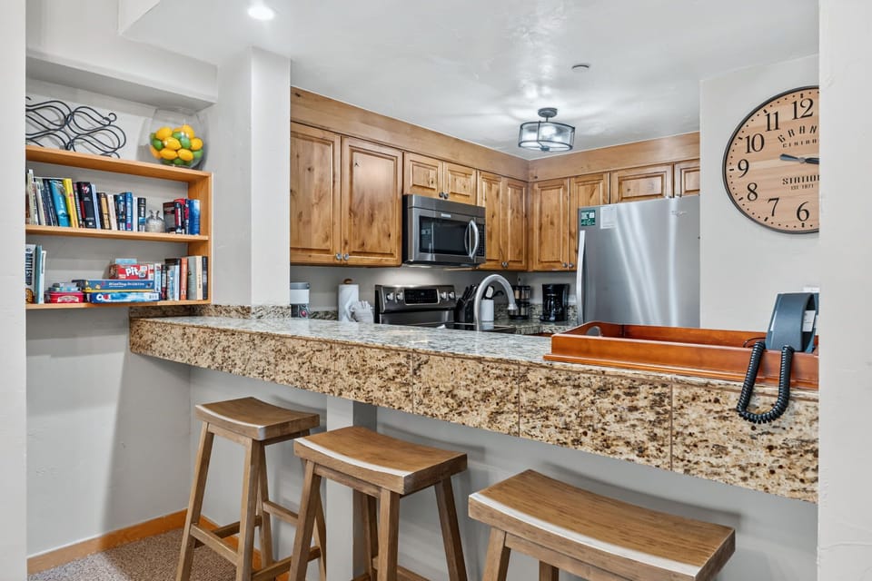 Your fully equipped kitchen offers granite counters, warm wood cabinetry, and stainless steel appliances—everything you need to whip up your favorite meals in comfort.