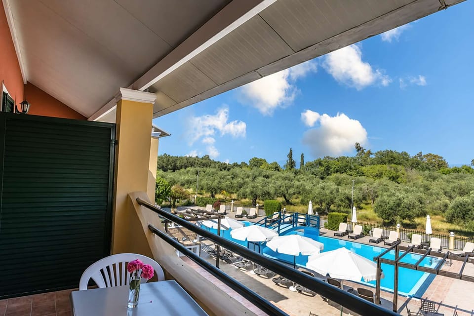 Your private furnished balcony overlooks the pool area, providing a relaxed setting for a morning coffee or a quiet evening outdoors.
