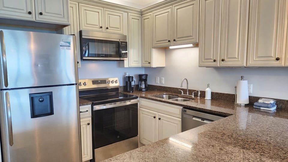 Bright granite kitchen with stainless appliances and ample counter space
