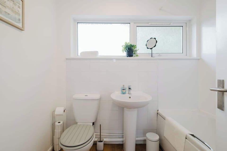 A bright and practical bathroom with a toilet and wash basin for your convenience.