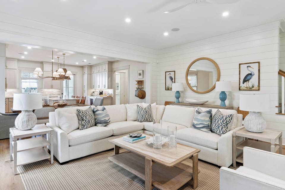 Unwind in a beautifully designed living space where coastal charm meets modern comfort. Sink into plush seating surrounded by soothing blue accents and natural light streaming through every corner.