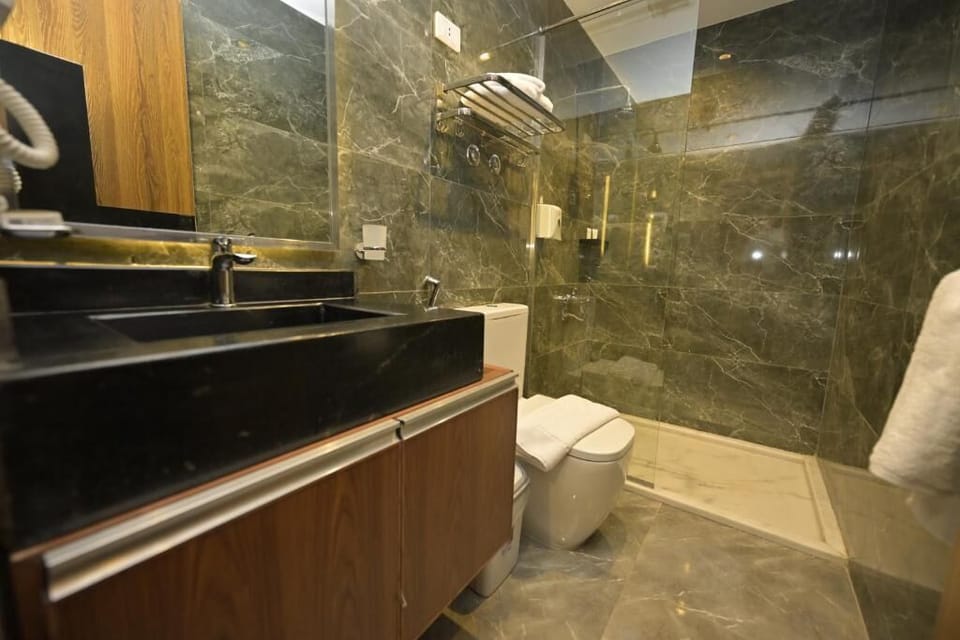 Luxury Triple Room, Balcony, City View | Bathroom | Hair dryer, slippers, towels, soap