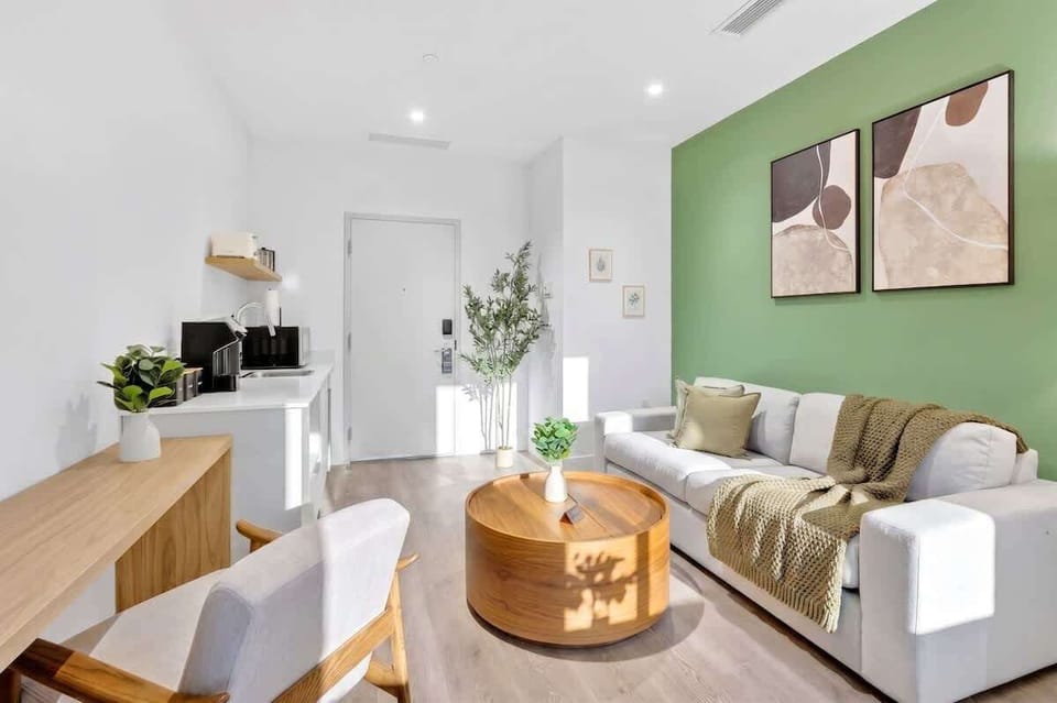 Relax in the comfortable living space featuring a sofa bed, Smart TV, and plenty of natural light.