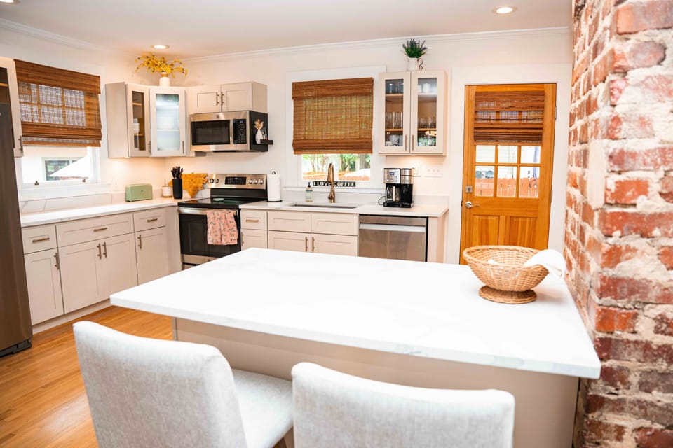 Kitchen with a counter/island area perfect to set up a work space. 