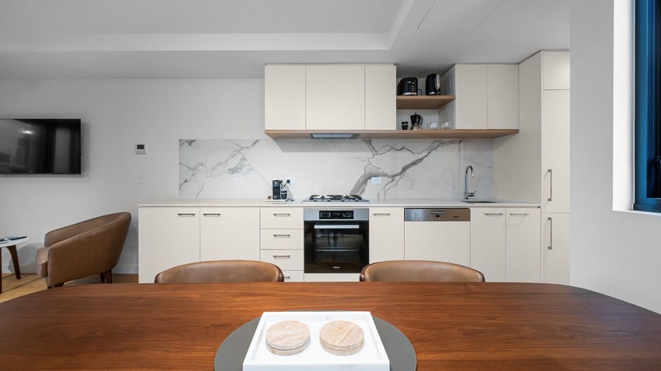 Fully equipped kitchen with modern appliances and dining space for shared meals.