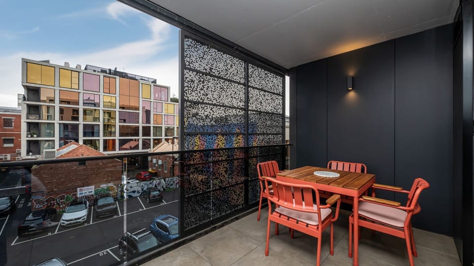 Private balcony with outdoor dining and views across the vibrant neighbourhood.