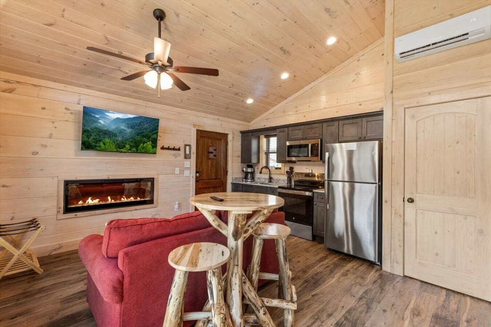 Living space with full kitchen, smart tv, dining, electric fireplace