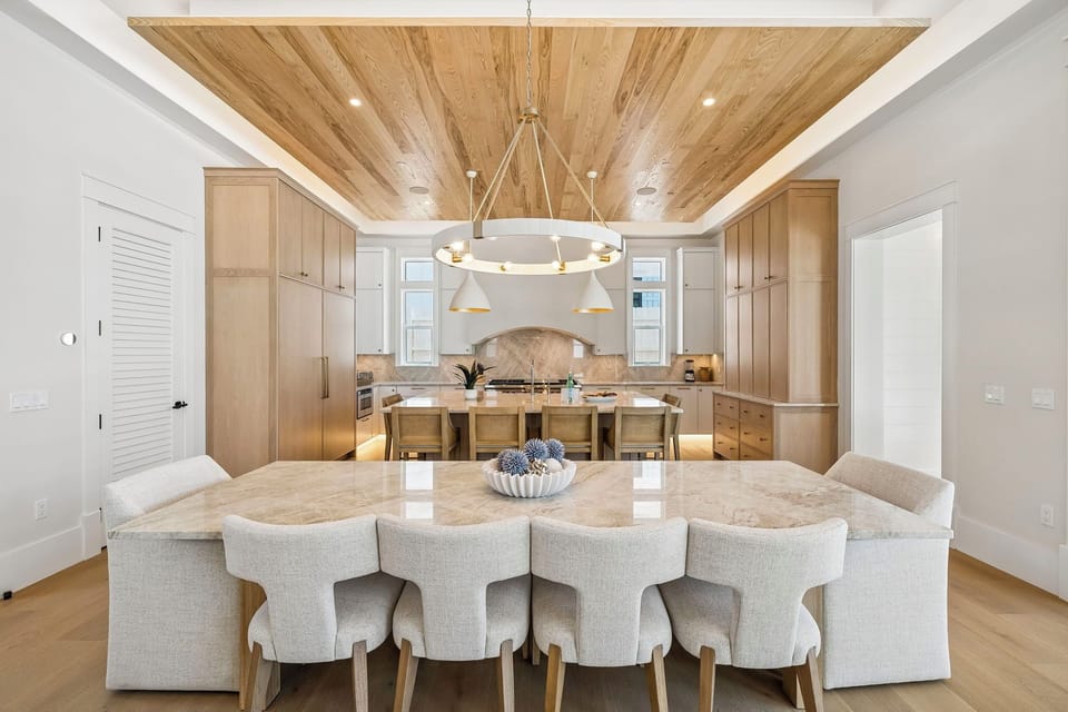 Picture yourself hosting unforgettable gatherings under the stunning wood-paneled ceiling, with gleaming marble surfaces and designer lighting creating the perfect ambiance for your culinary adventures.