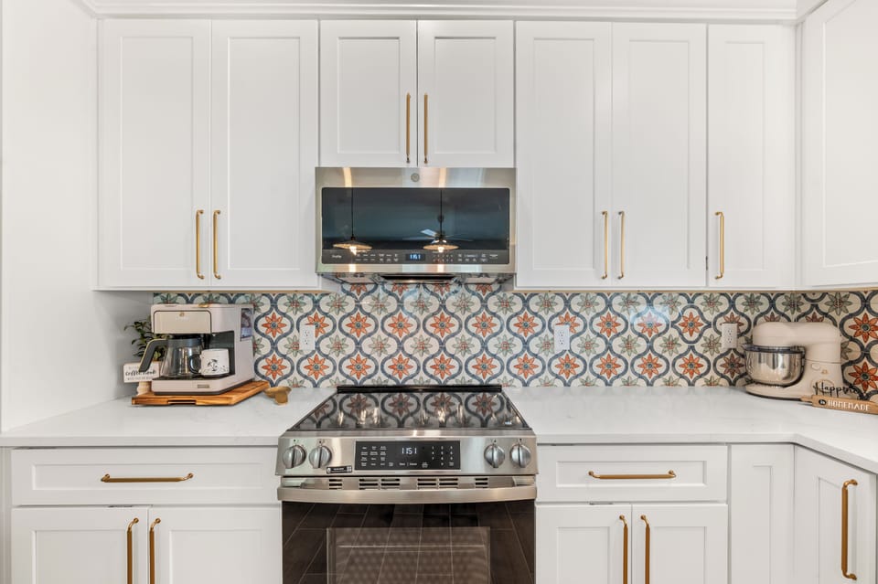 Vacation‑ready kitchen with stand mixer, small appliances, and air‑fryer oven