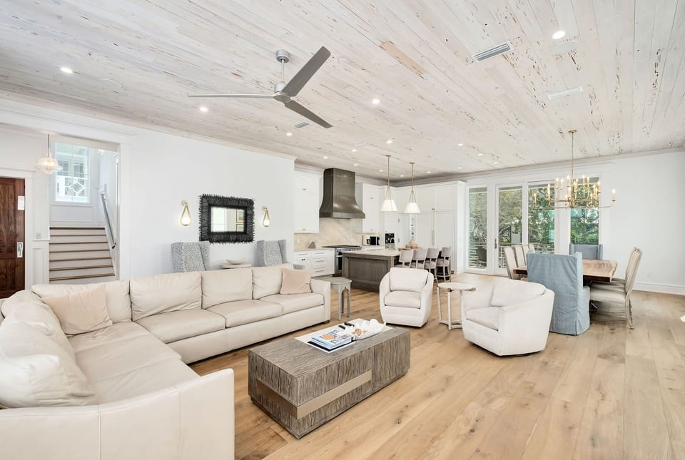 Bright, spacious living area with vaulted ceilings, plush seating, and seamless flow to a chef's kitchen—perfect for gathering and making memories together.