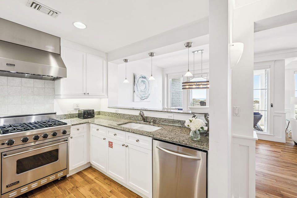 Step into a sparkling, fully-equipped kitchen where your vacation culinary adventures begin—complete with granite counters, modern appliances, and plenty of space to gather.