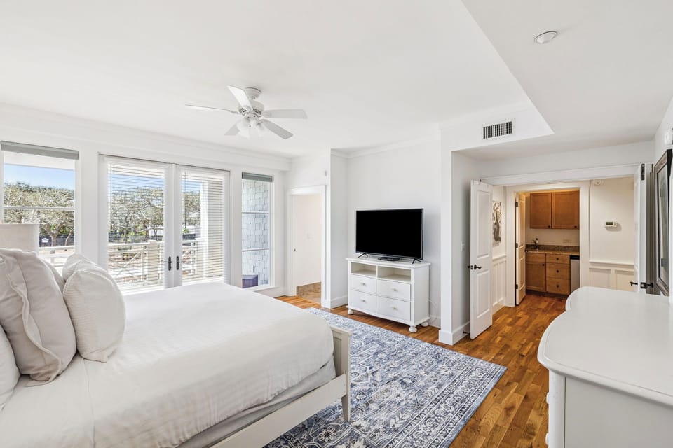 Picture yourself unwinding in this serene bedroom, where natural light floods through expansive windows and a plush bed awaits. Your private en-suite bath offers added comfort and convenience.