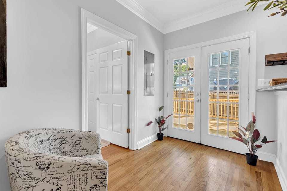 Bright entry with French doors opening to a sunny private deck
