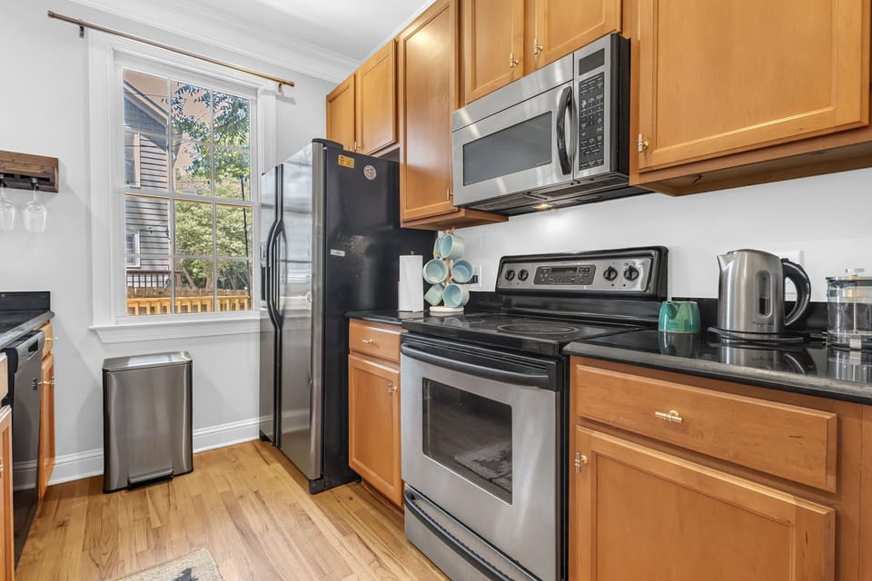 Bright kitchen with stainless appliances, natural light, and ample cabinet space