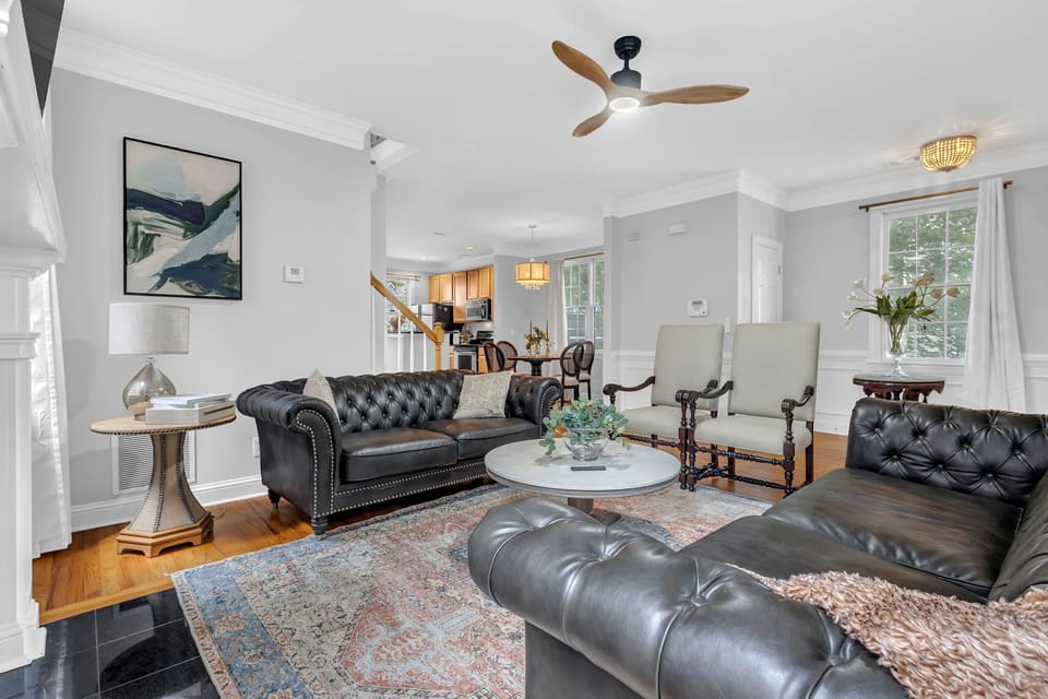 Bright open living room with leather seating and elegant, airy design