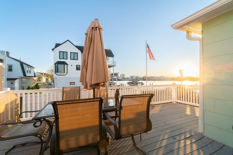 Relax on the private deck featuring comfortable outdoor seating, a patio umbrella for shade, and stunning views.