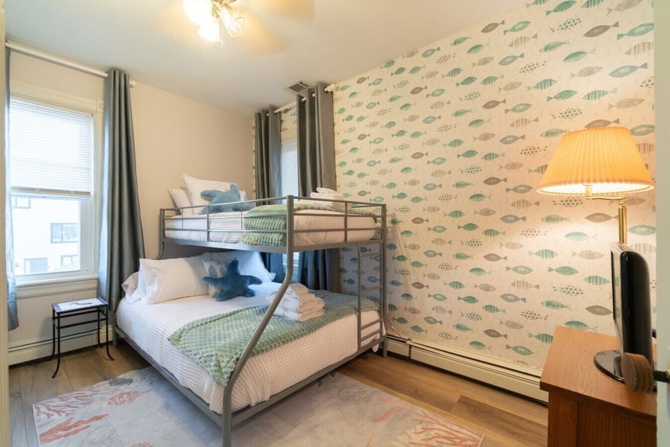 This bedroom features a bunk bed with a queen-size bed on the bottom and a twin bed on top, making it ideal for families and groups. A Smart TV is also provided for your entertainment.