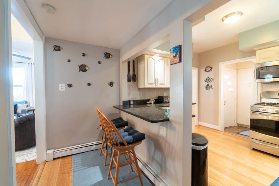 The kitchen counter offers casual seating for two, making it the perfect spot to enjoy breakfast, a quick meal, or your morning coffee.
