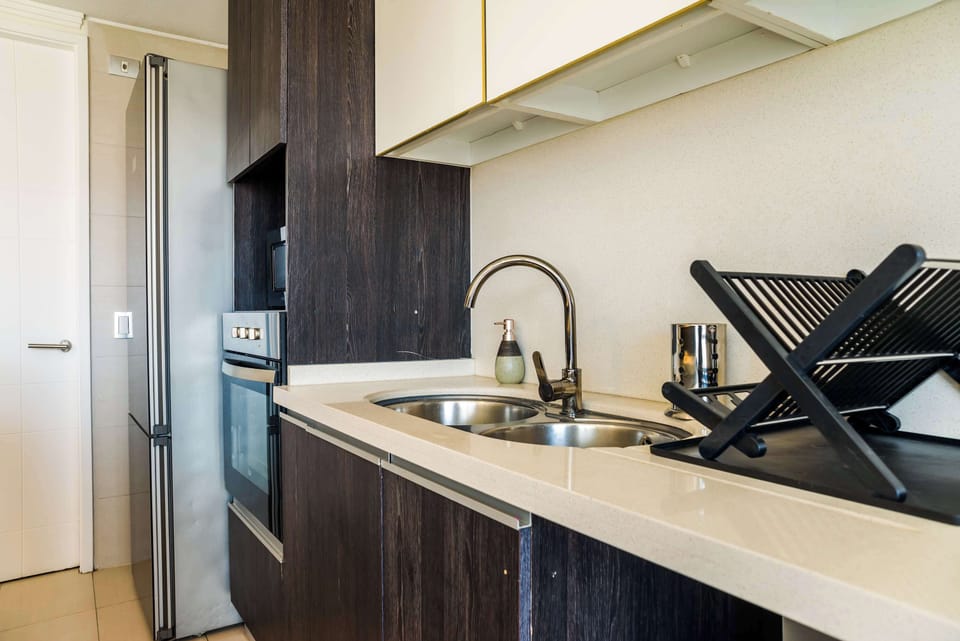 Sleek and modern kitchen with stainless steel appliances and ample counter space, perfect for home-cooked meals.