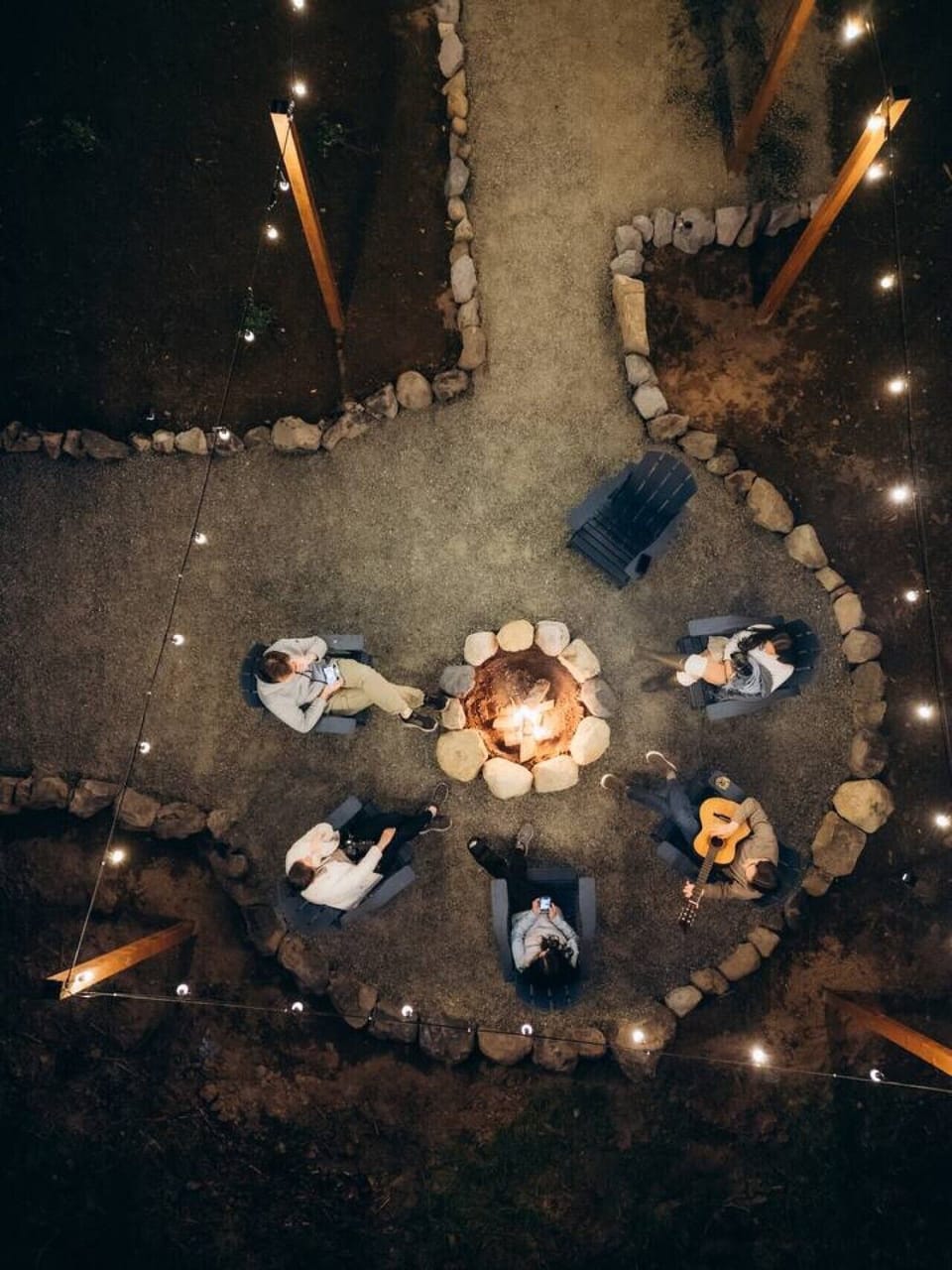 Outdoor Fire Pit: Gather under the string lights, relax in Adirondack chairs, and enjoy cozy evenings around the fire.