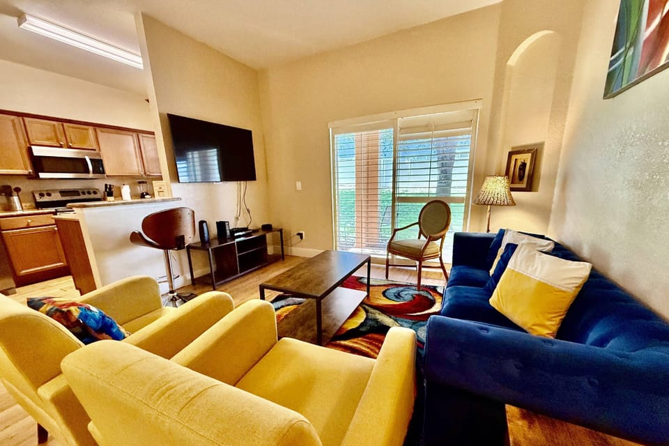 Bright and colorful living room with access to the rear patio