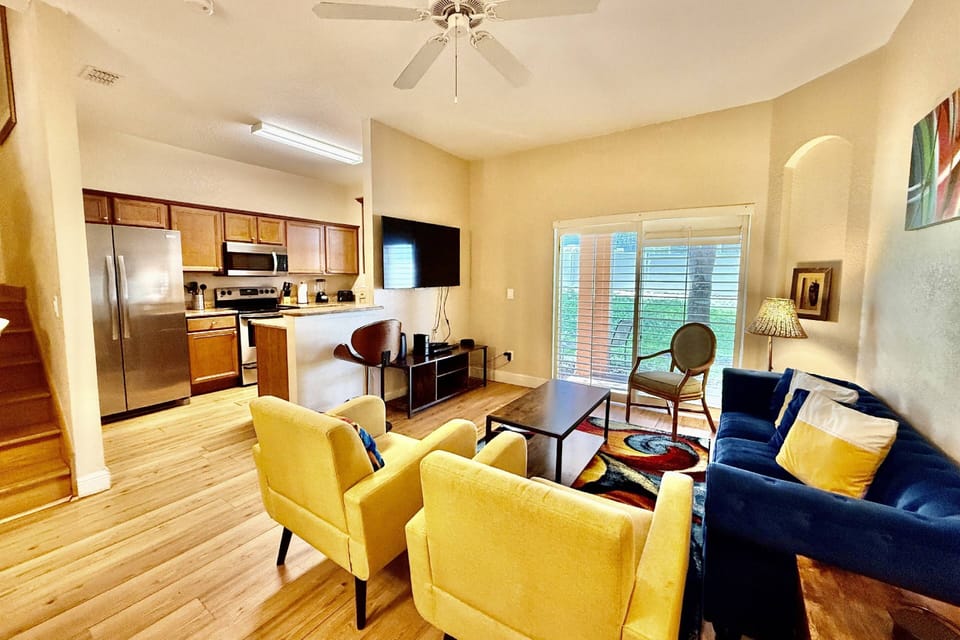 Bright and colorful living room with access to the kitchen and dining room