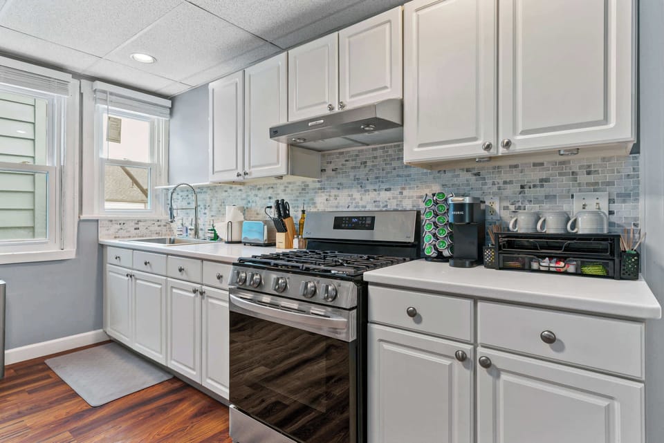 Enjoy the convenience of a bright, fully equipped kitchen with modern appliances, ample counter space, and a complimentary coffee station—perfect for everything from quick breakfasts to home-cooked meals with your group.