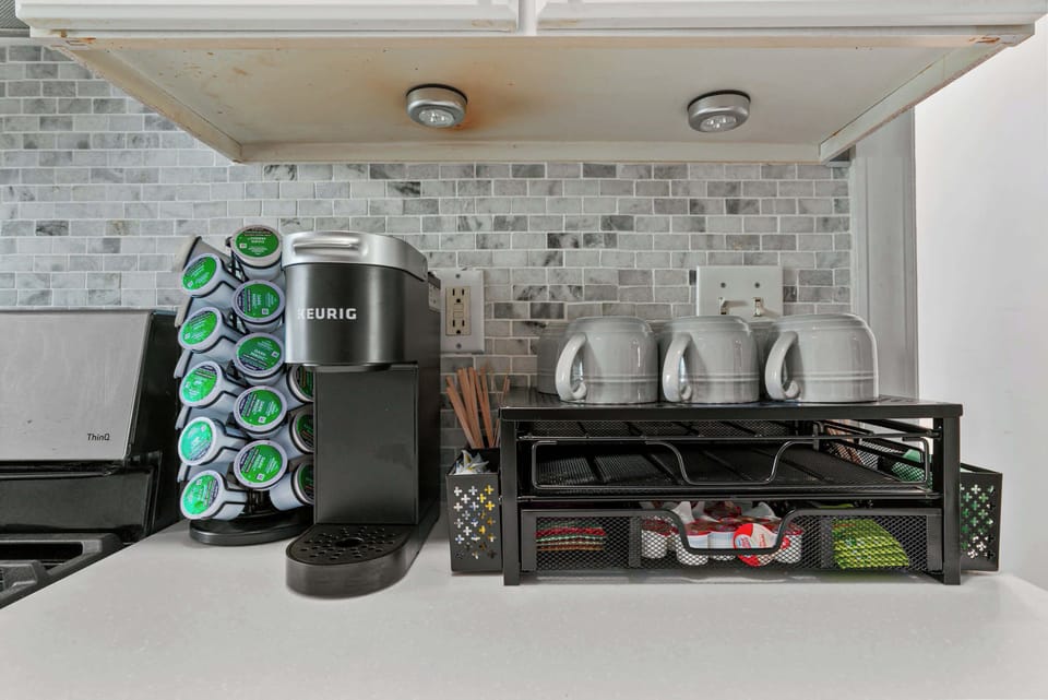 Start your morning with ease at the fully stocked coffee station, featuring a Keurig, mugs, and complimentary essentials—perfect for fueling up before a day of exploring or working remotely.