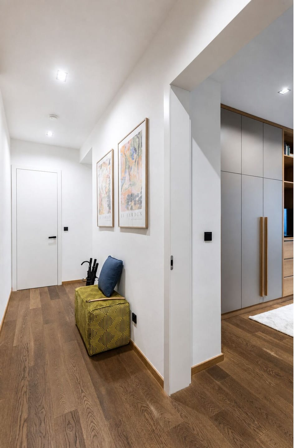 Bright modern entry hall with built-in storage and warm designer touches