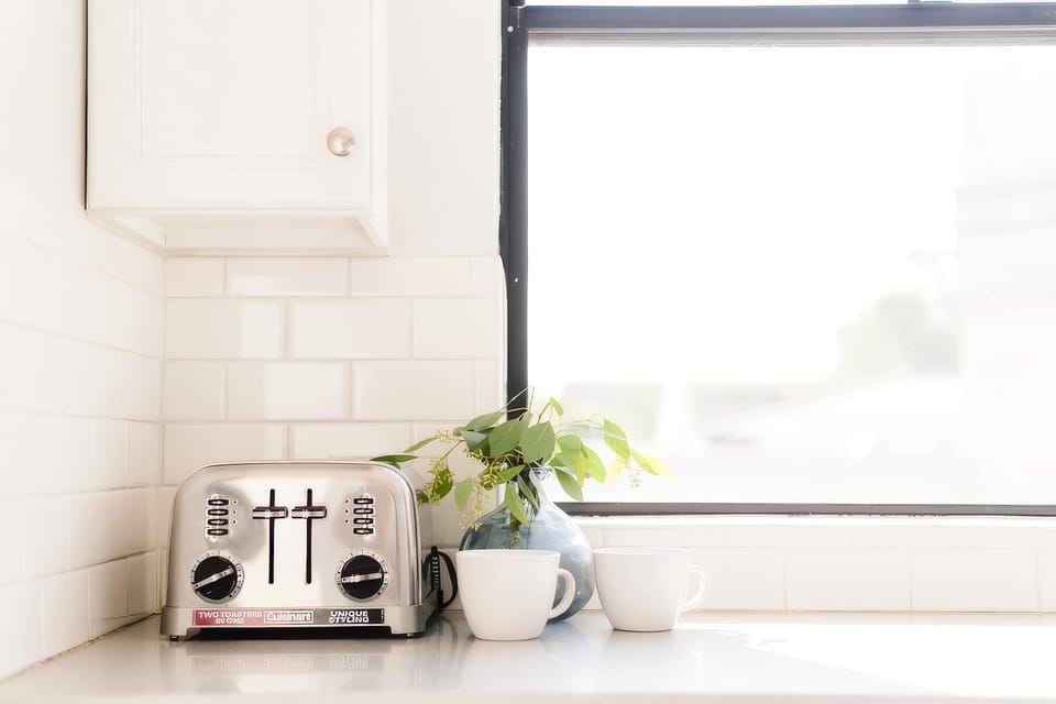 Sleek, well-equipped kitchen with stainless steel appliances, ample prep space, bar seating, and everything you need for meals, snacks, and easy entertaining.