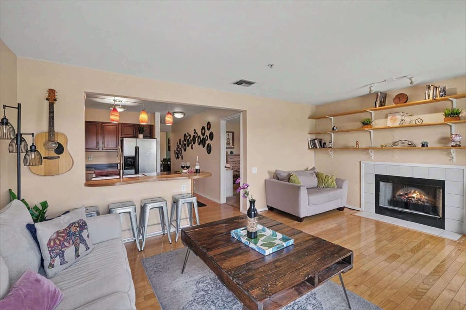 Inviting living room with a cozy fireplace, comfortable seating, Nashville-inspired décor, and a private balcony with peaceful views.