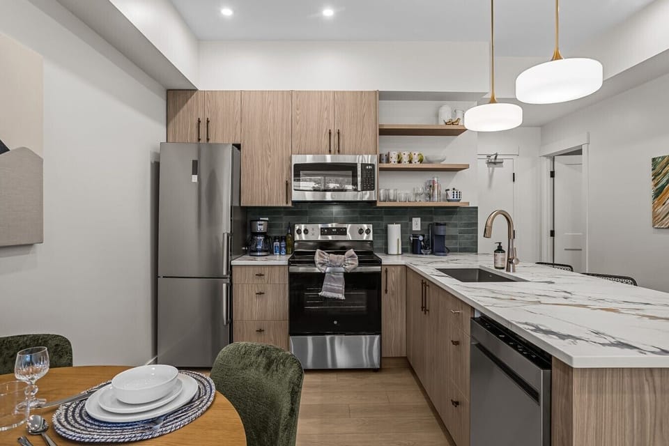 rundle-nook-canmore-kitchen-stainless-appliances-green-backsplash