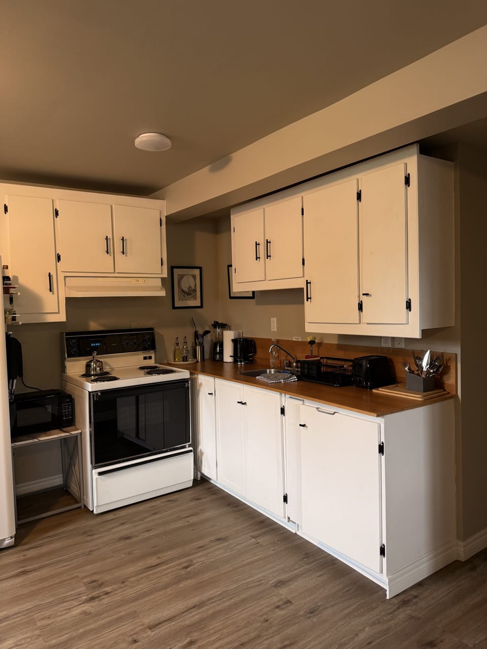 Bright, fully equipped kitchen with ample storage and warm wood counters