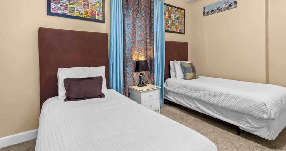 Bedroom 2 with 2 twin beds, Smart TV, and ensuite 