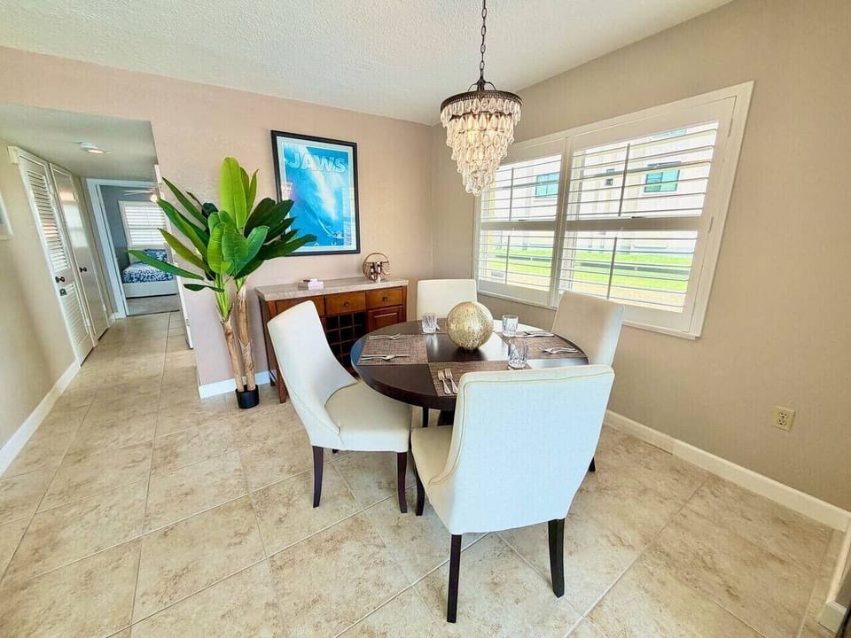 Elegant dining area with seating for four, perfect for meals and game nights.