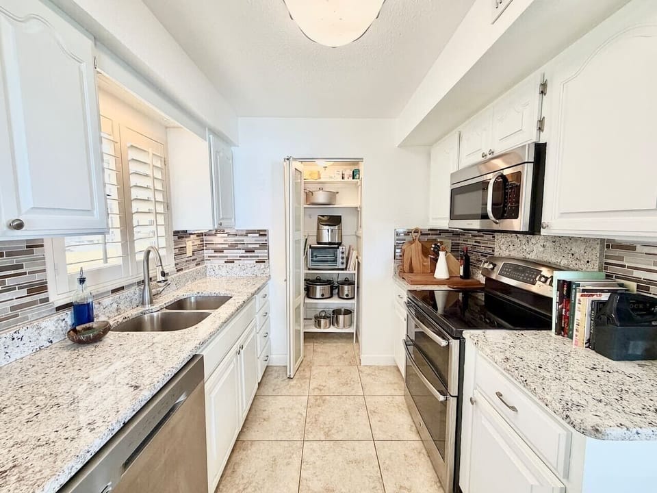 Updated kitchen with stainless steel appliances and ample counter space.