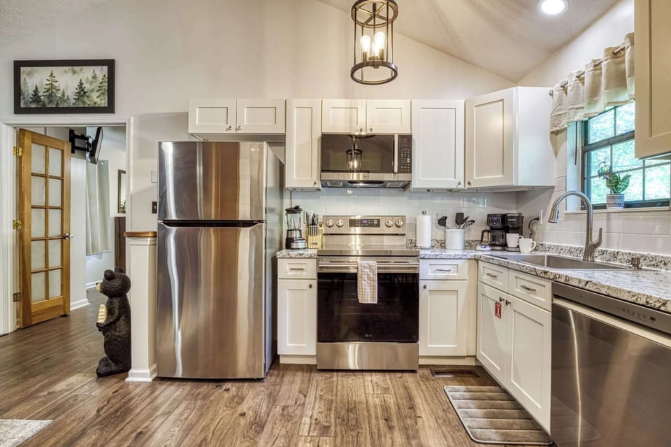 The fully equipped kitchen features stainless steel appliances and everything you'll need to prepare breakfast before adventures or dinner after a day in the Smokies.
