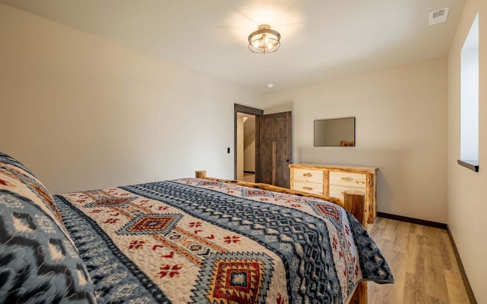 Bedroom 2 on the lower level features a King size bed and lodgepole wood frame
