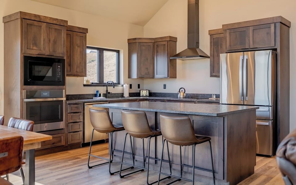 Large kitchen island with breakfast bar is the perfect spot to map out your day's adventures
