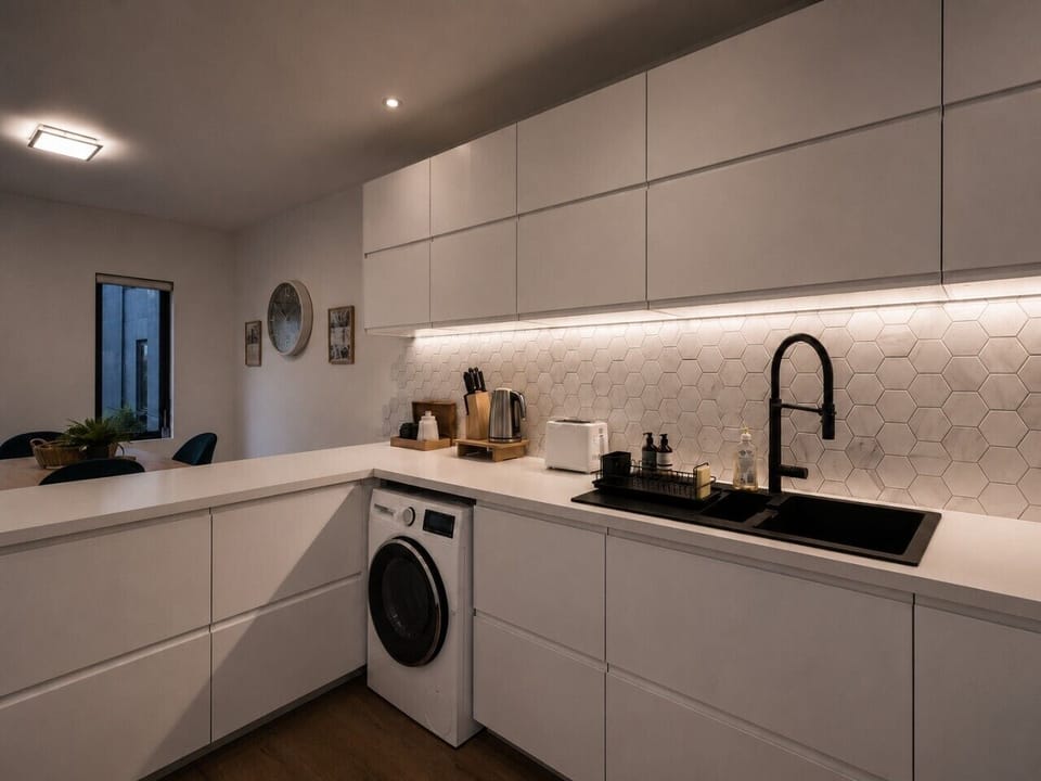 The kitchen is fully equipped for a convenient stay. The dual washer-dryer machine is located in the kitchen.