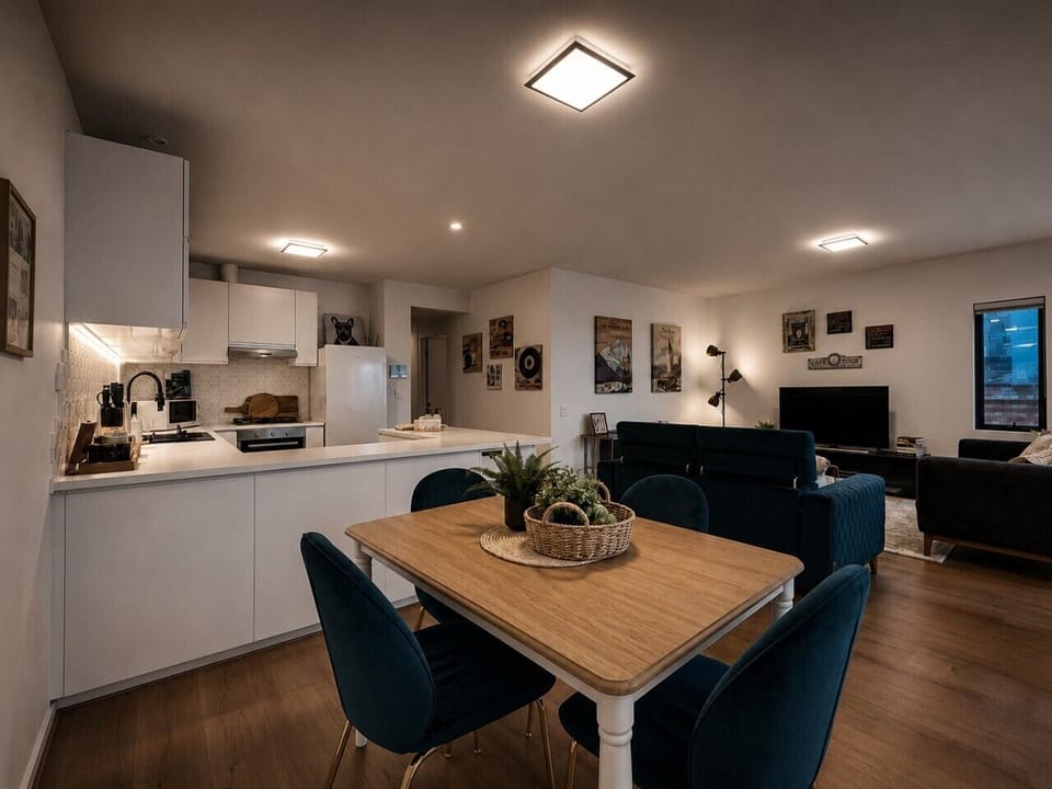 The dining table can comfortably seat four guests in a spacious area.