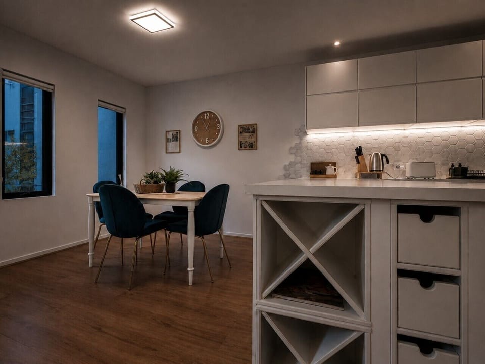 The dining table can comfortably seat four guests in a spacious area.