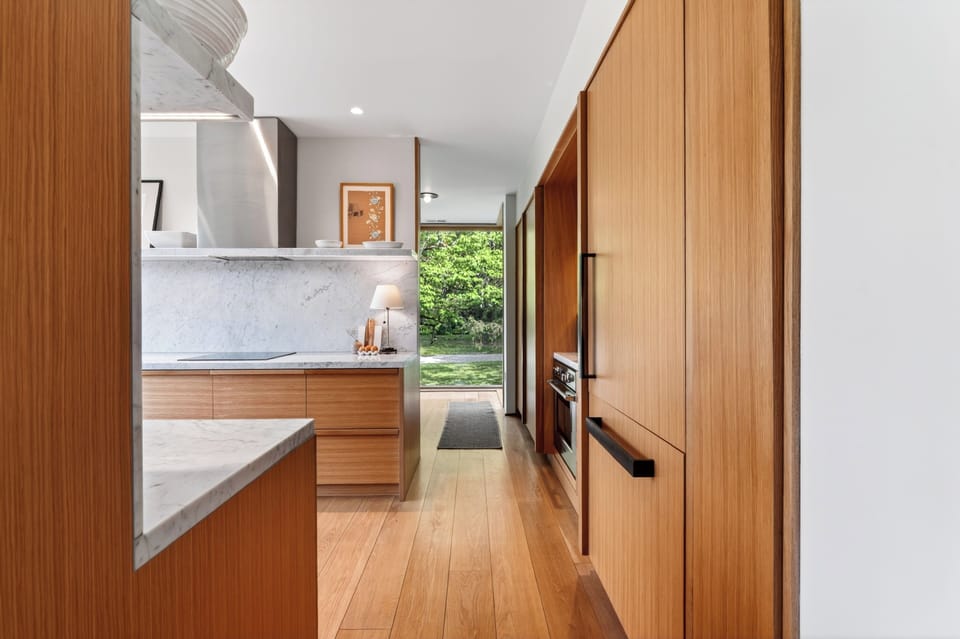 Bright, linear design and premium stainless steel features elevate this streamlined culinary workspace.