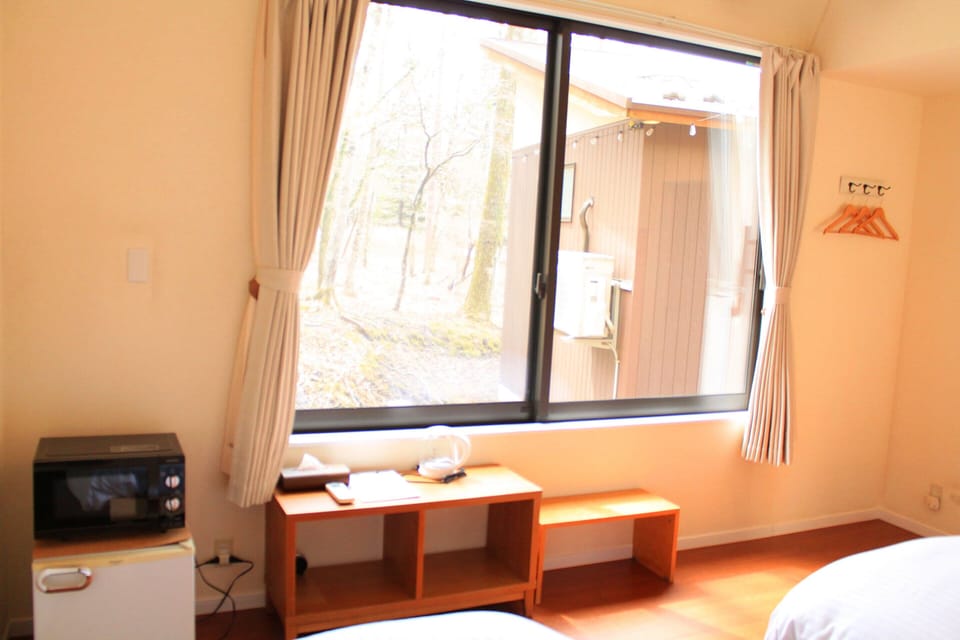 Deluxe Twin Room, Garden View | Desk, laptop workspace, blackout drapes, free WiFi
