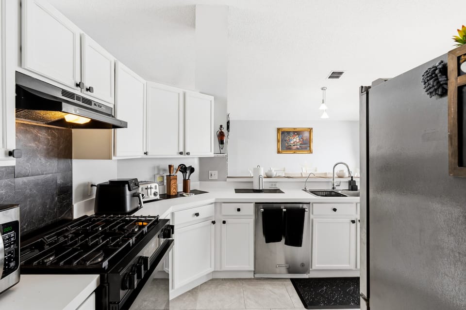 Cook with ease in the fully equipped kitchen featuring modern appliances, ample counter space, and everything needed for family meals and entertaining.