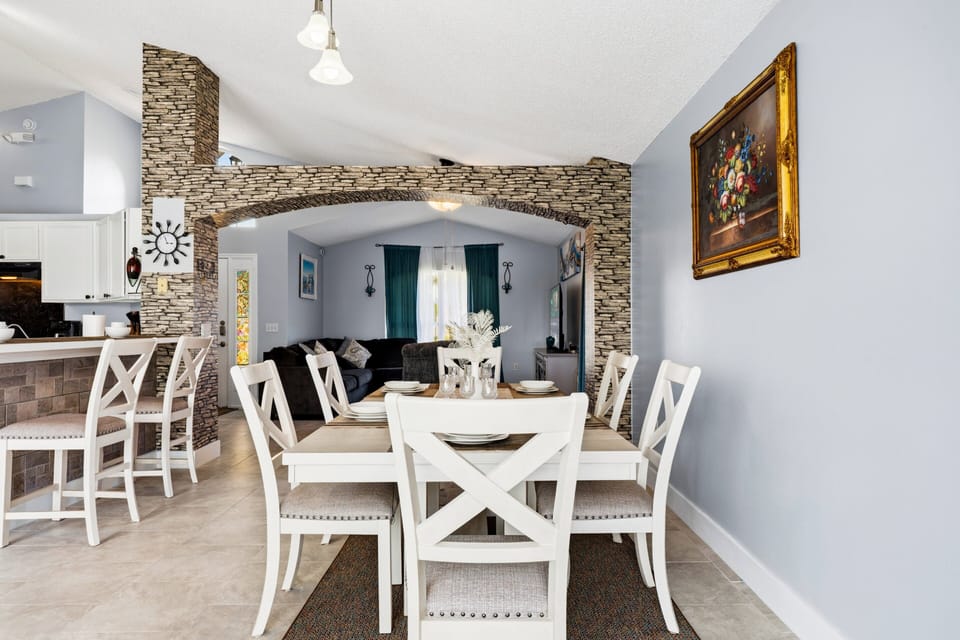 Enjoy meals together in this stylish dining area featuring seating for family and friends, elegant décor, and an open layout connected to the main living spaces.